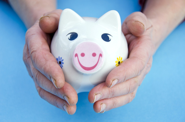 Piggy bank in the old woman hands - Photo, Image