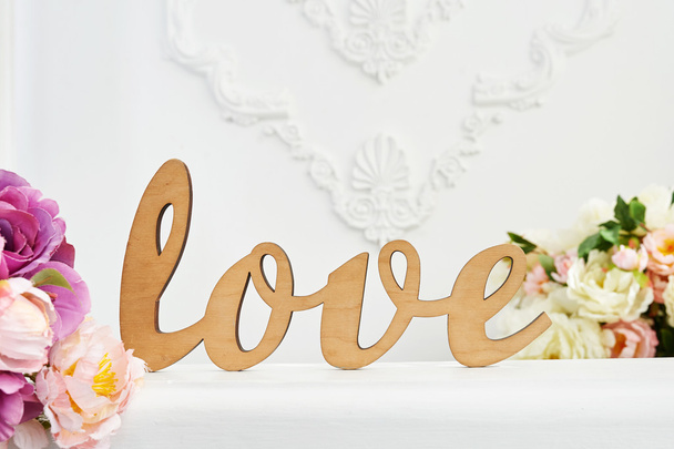 wooden word Love against white wall in the studio - Photo, Image