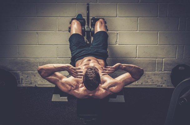 Muscular man doing exercises  - Foto, Imagen