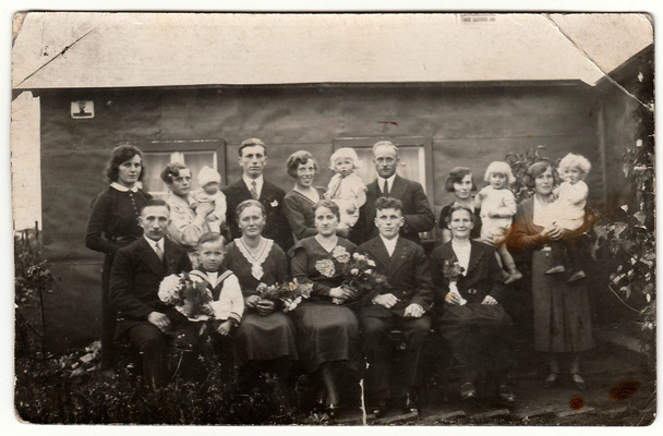 Vintage photo shows a big family poses behind house.  Black & white antique photography. - Photo, Image