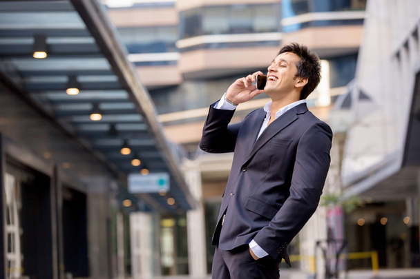 Portrait of confident businessman with mobile phone outdoors - Фото, изображение