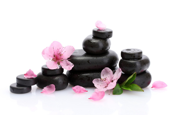 Spa stones with drops and pink sakura flowers isolated on white - Fotografie, Obrázek