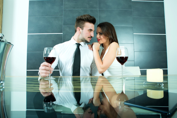 A romantic couple with a glass of wine in the dining room	 - Foto, Imagem