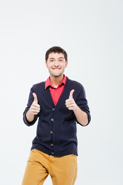 Smiling casual man showing thumbs up - Foto, afbeelding
