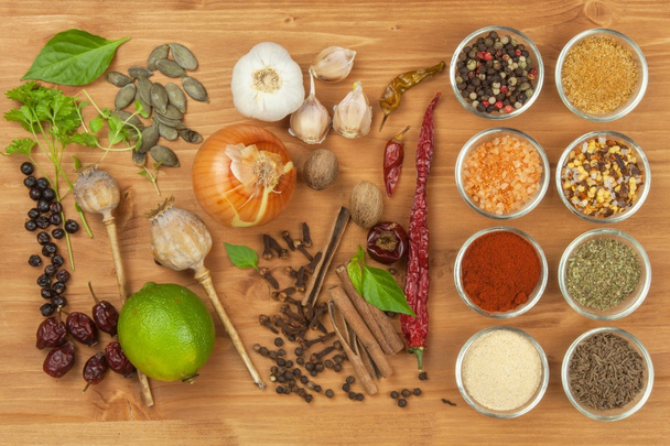The joy of cooking, preparation of spices. Various kinds of spices on a wooden board. Food preparation. Spices on the kitchen table. - Foto, Imagem