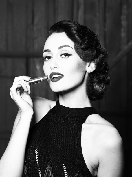 Young retro woman with lipgloss - Foto, afbeelding