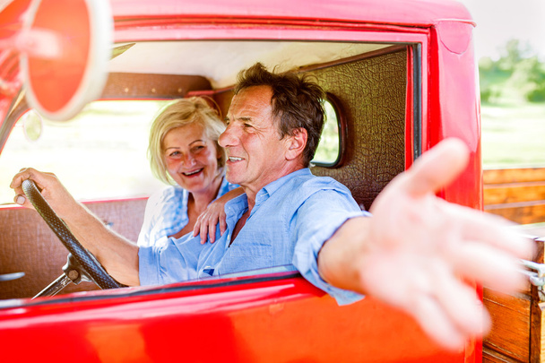 senior couple inside pickup truck - Фото, изображение