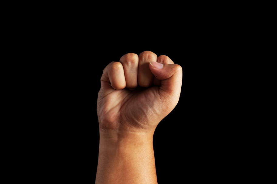 Closeup of human male hand - raised up clenched fist, on white background - Photo, Image