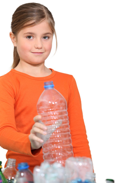 Girl recycling plastic bottles - 写真・画像