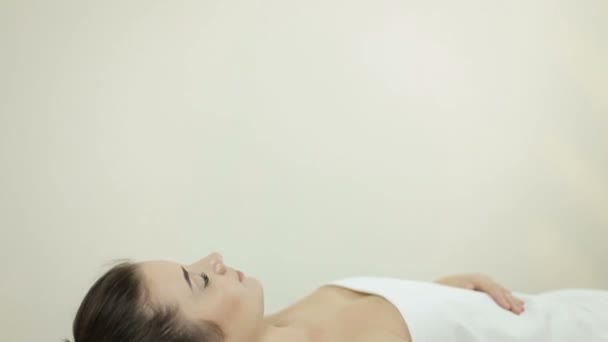 Woman getting facial massage in spa - Materiał filmowy, wideo