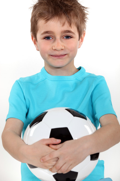 Boy holding a football ball - Fotoğraf, Görsel