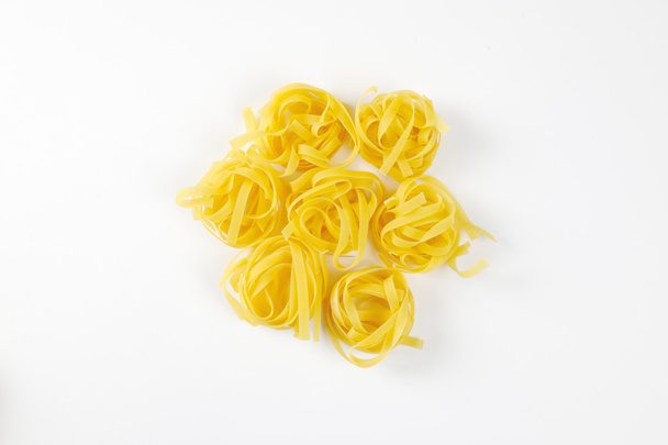Nests of dry pasta tagliatelle - Photo, Image