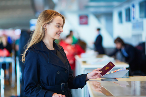 Young female traveler in international airport - 写真・画像