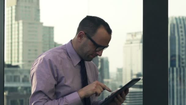 Successful businessman with tablet computer on terrace - Felvétel, videó