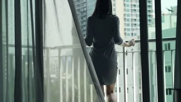 Businesswoman listening to music on cellphone, dancing on terrace - Кадри, відео