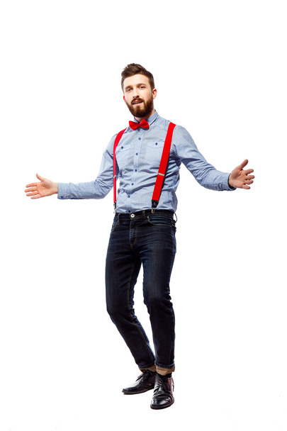 stylish guy in the blue shirt with red bowtie and suspenders isolated on white. dancing, gesturing - Фото, зображення