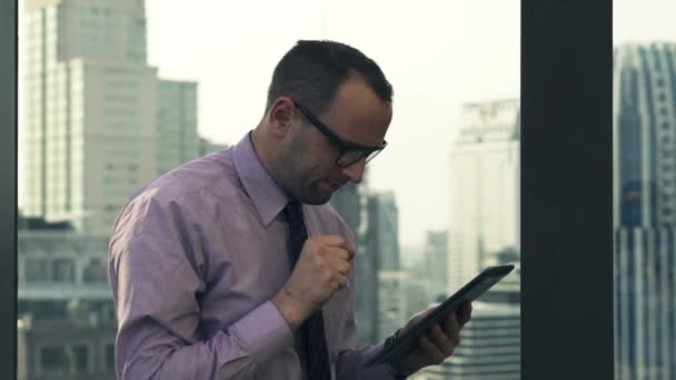 Successful businessman with tablet computer on terrace - Felvétel, videó