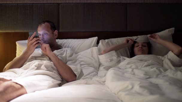 couple fighting, arguing in bed at night - Materiał filmowy, wideo