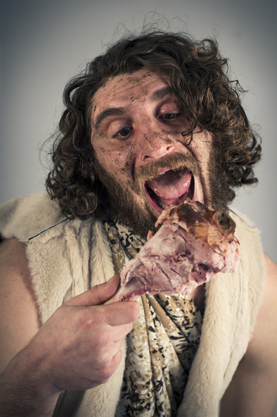 Realistische Caveman eten - Foto, afbeelding