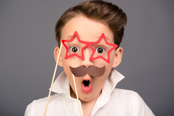 Close up portrait of surprised funny schoolboy holding props - Zdjęcie, obraz