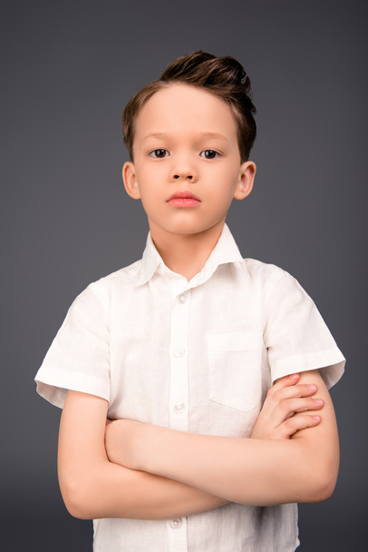 Portrait of cute little boy posing with crossed hands - Фото, изображение