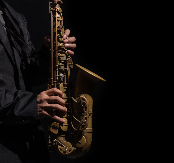 Closeup saxophone in player action on a dark background - Photo, Image