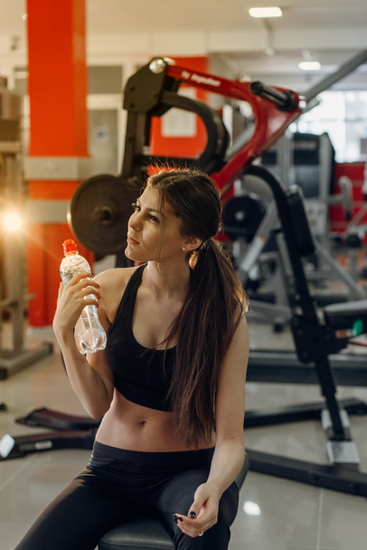 Beautiful girl with water at the gym - Foto, immagini