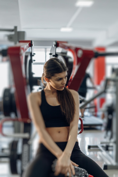 Beautiful girl with water at the gym - Foto, Bild