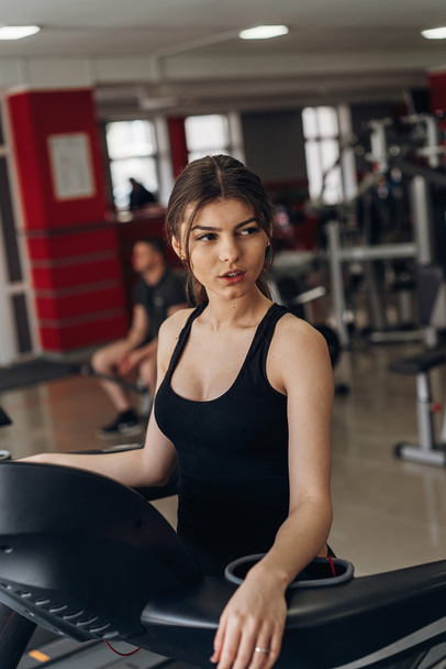 Beautiful brunette on a treadmill - 写真・画像