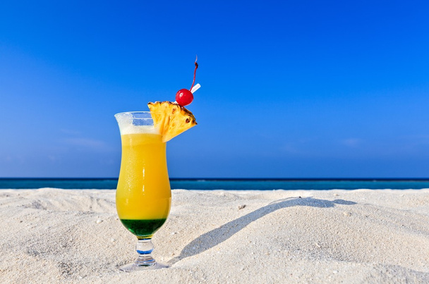 Fruity cocktail is on a beach - Photo, image