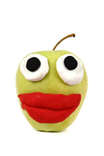 Green apple with plasticine smile - Photo, Image