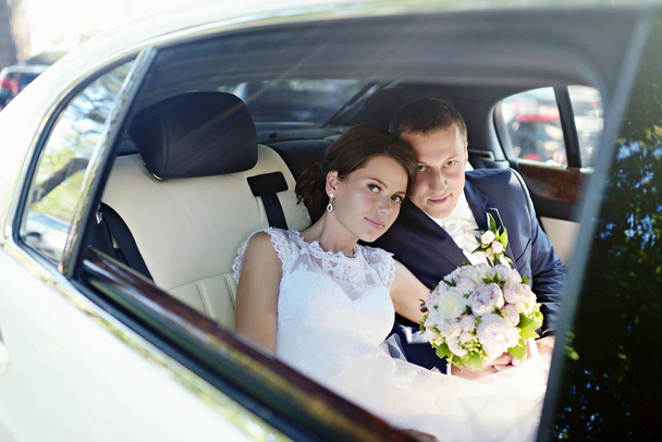 Wedding couple hugging in car - Photo, Image