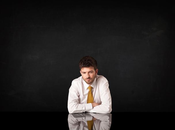 Businessman sitting at a desk - Фото, изображение