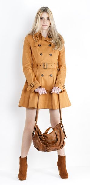 Standing woman wearing coat and fashionable brown shoes with a h - Фото, зображення