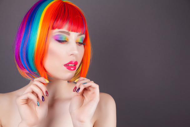 beautiful woman wearing colorful wig and showing colorful nails  - Zdjęcie, obraz
