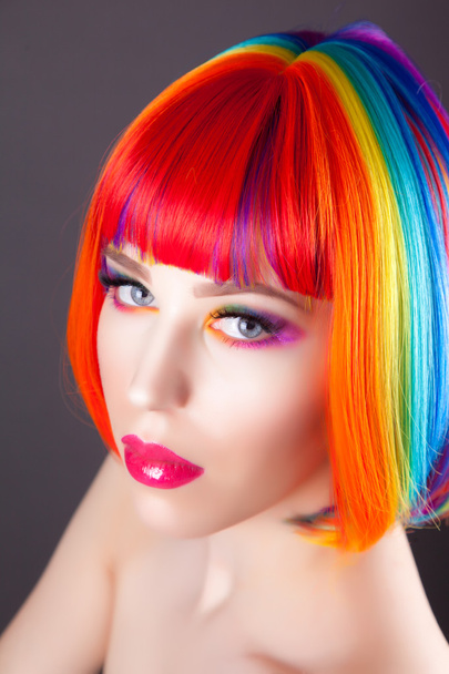 beautiful woman wearing colorful wig and showing colorful nails  - Fotó, kép