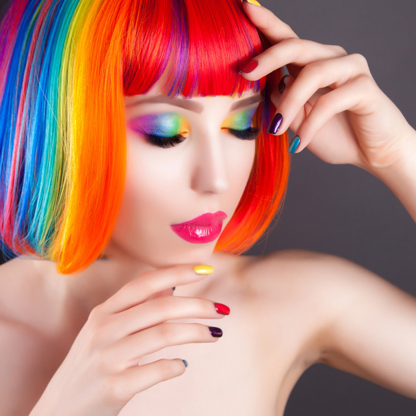 beautiful woman wearing colorful wig and showing colorful nails  - Fotó, kép