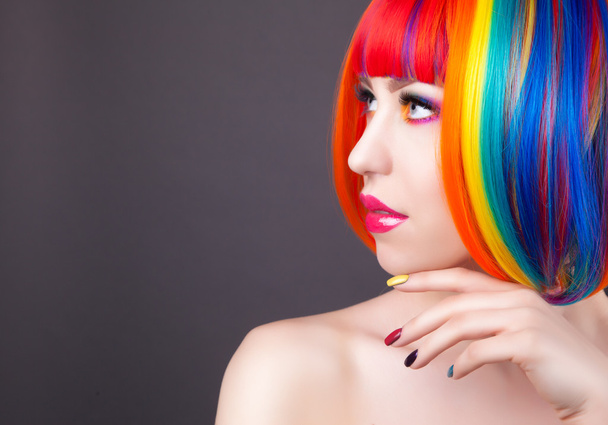 beautiful woman wearing colorful wig and showing colorful nails  - 写真・画像