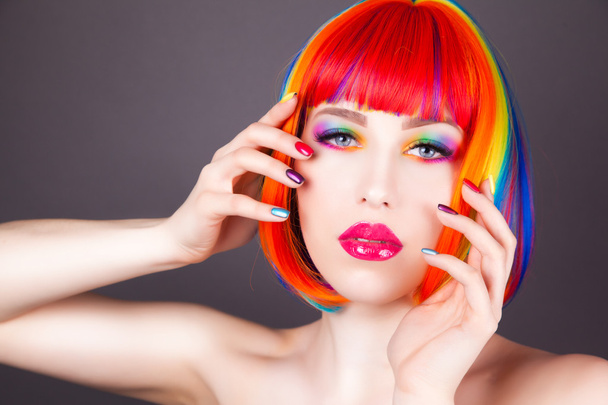 beautiful woman wearing colorful wig and showing colorful nails  - Фото, зображення