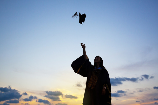 Silhouette Of Young Female Student Celebrating Graduation - Foto, afbeelding