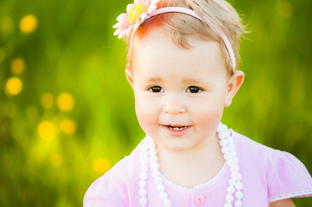 Portrait of beautiful little girl at sunny meadow background - Photo, image