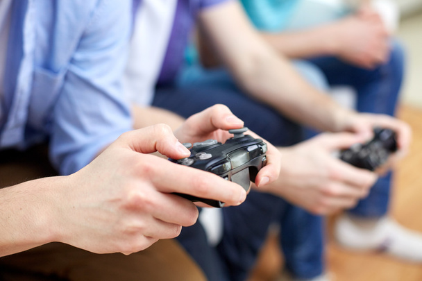 close up of friends playing video games at home - Foto, Imagem