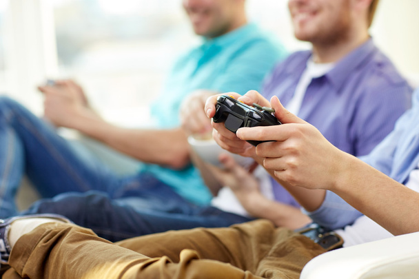 close up of friends playing video games at home - Φωτογραφία, εικόνα
