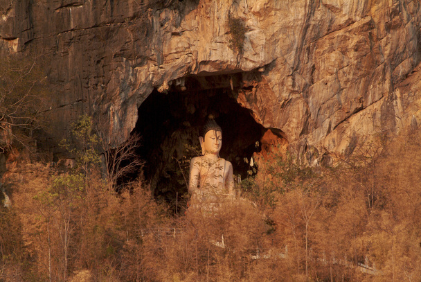 Buddha on the cave . - Фото, изображение