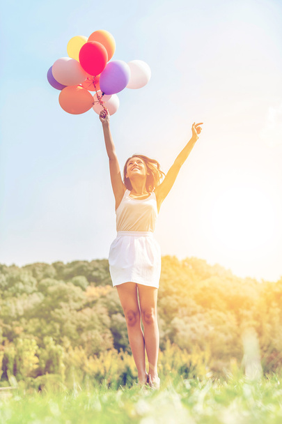 woman holding colorful balloons - Photo, Image