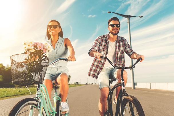 couple smiling and riding on bicycles - Foto, imagen