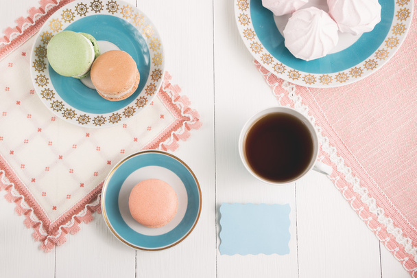 Tea with sweets and card on white background. Selective focus, top view, macro, toned image, film effect - Photo, Image