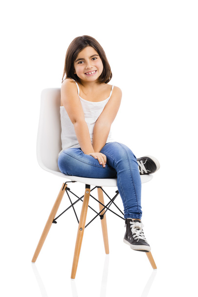 Beautiful young girl sitting on a chair - Fotoğraf, Görsel