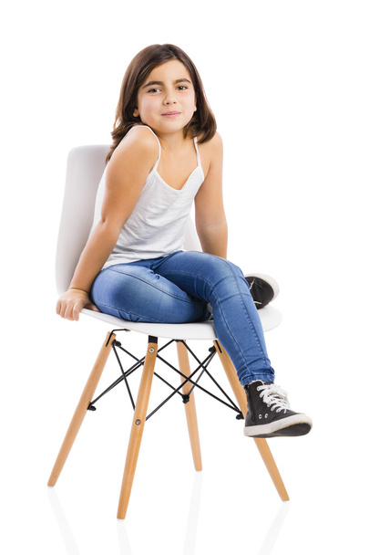 Beautiful young girl sitting on a chair - Foto, Bild