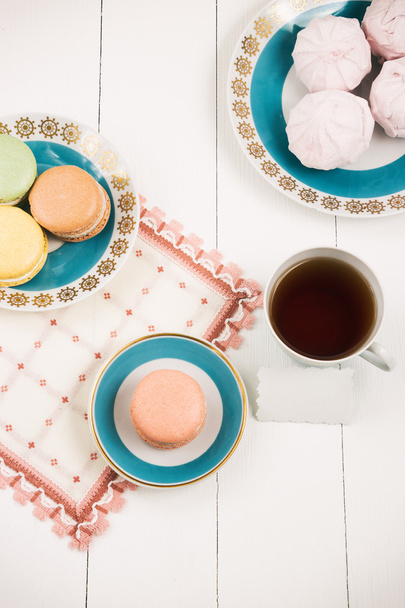 Tea with sweets and card on white background. Selective focus, top view, macro, toned image, film effect - Photo, image